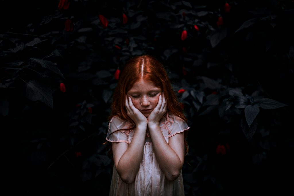 girl with red hair, surrounded by red roses. claire gillies blog. Learn How To Stop Taking Things To Heart
