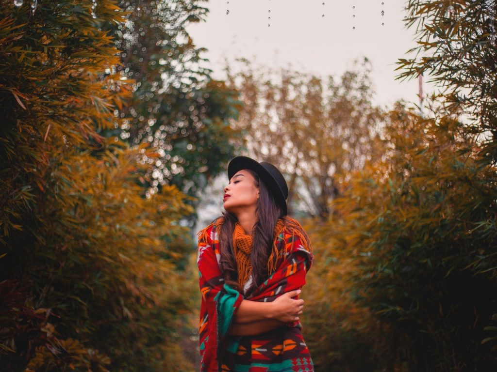 woman in forest wearing shawl. 