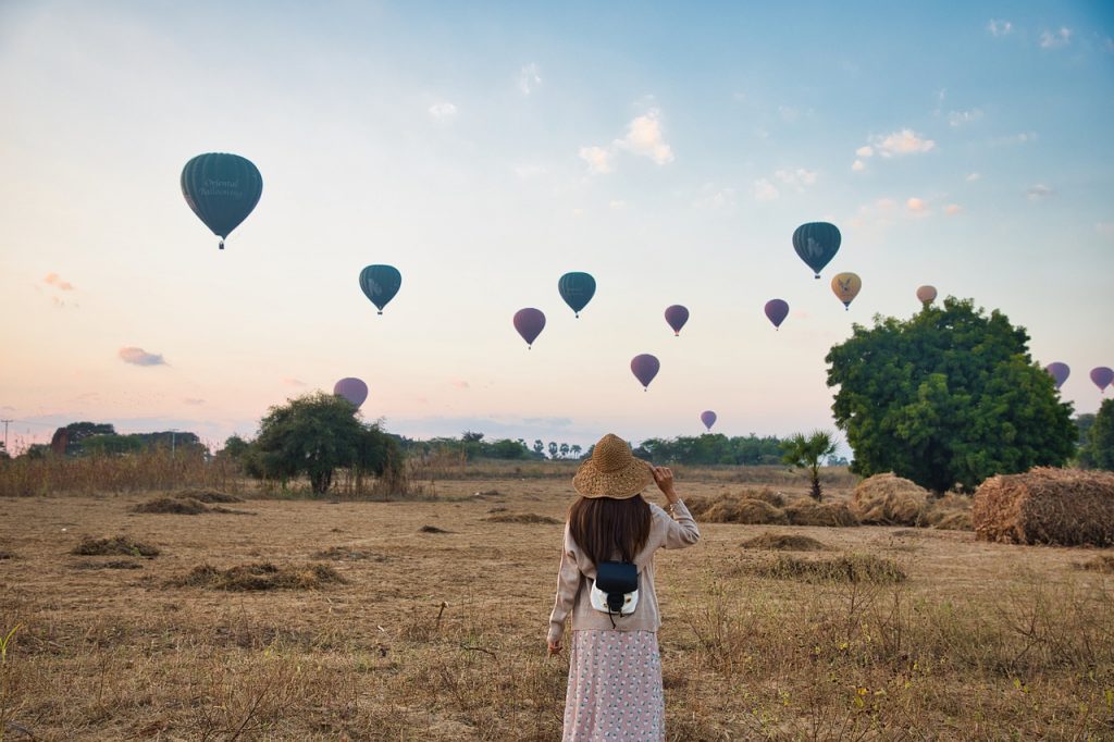 woman looking at hot air balloons. How to manifest the life you want. Claire Gillies blog