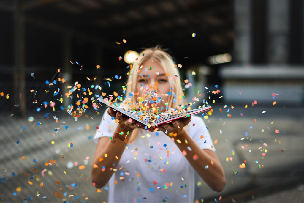 Woman blowing glitter. Reaching Your Goals With Easy Strategies - Claire Gillies Blogger Author